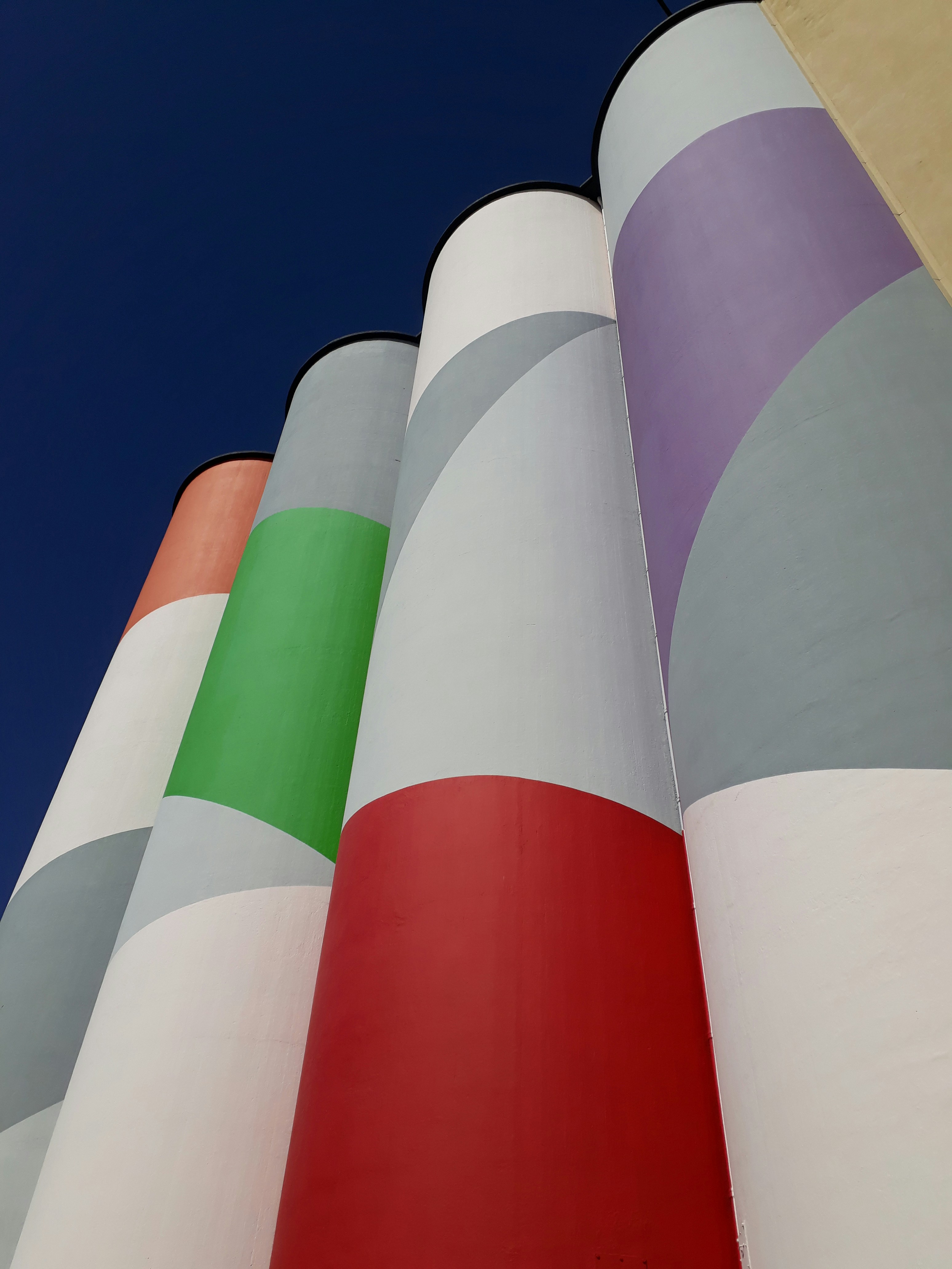 Construction of silos, painted in various colors, refurbished to now function as a museum. The exterior walls are painted in white, gray, red, violet, green, and orange